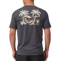 Back view of a man wearing the dark gray Siesta Performance Shirt with a beach hammock graphic and palm trees.