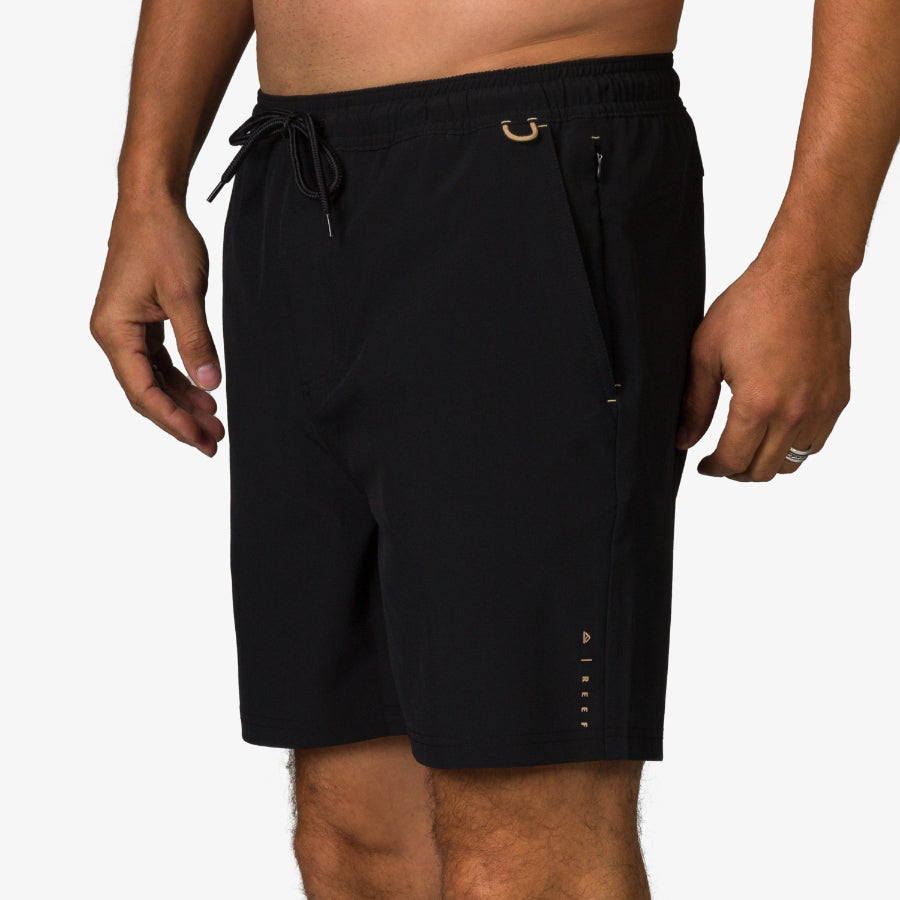 Men's Rushmore Hybrid Short side view showing black fabric, zippered pocket, and adjustable waistband for beach comfort.