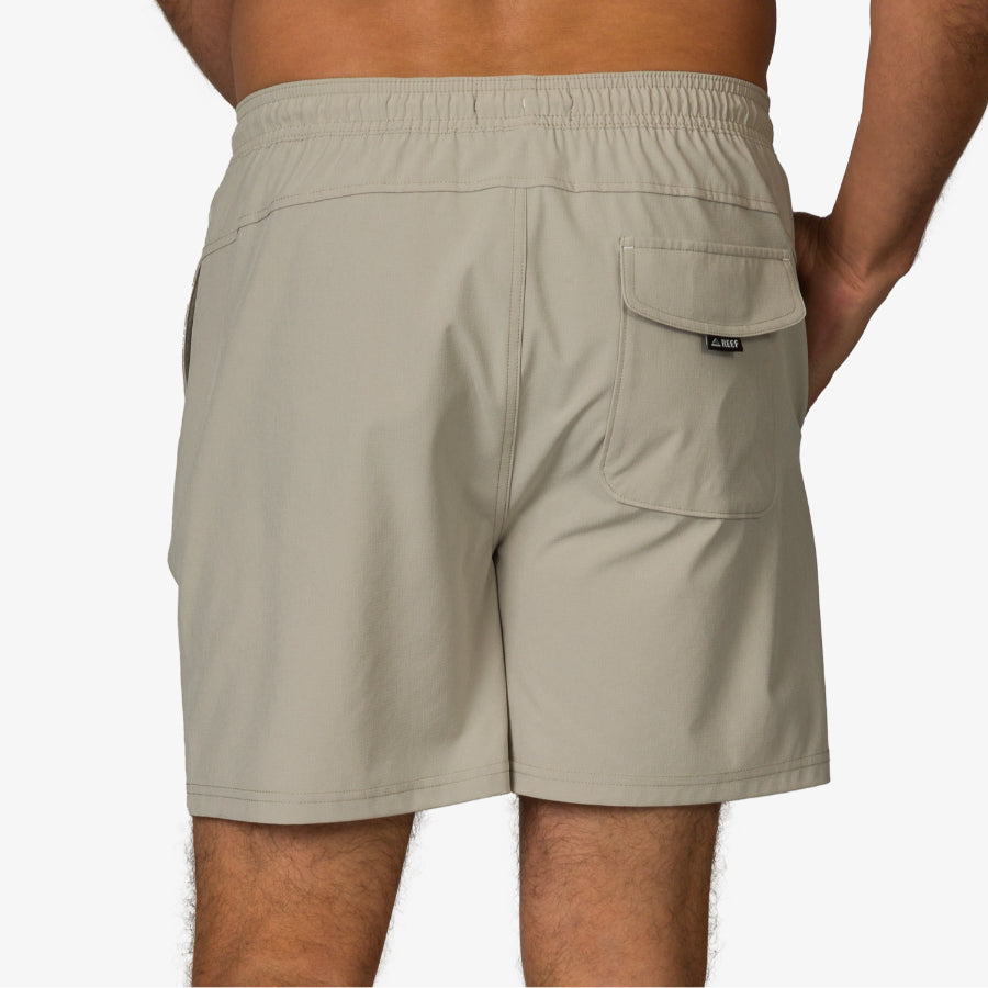 Back view of men's Rushmore Hybrid Short in stone color showing elastic waistband and rear pocket flap