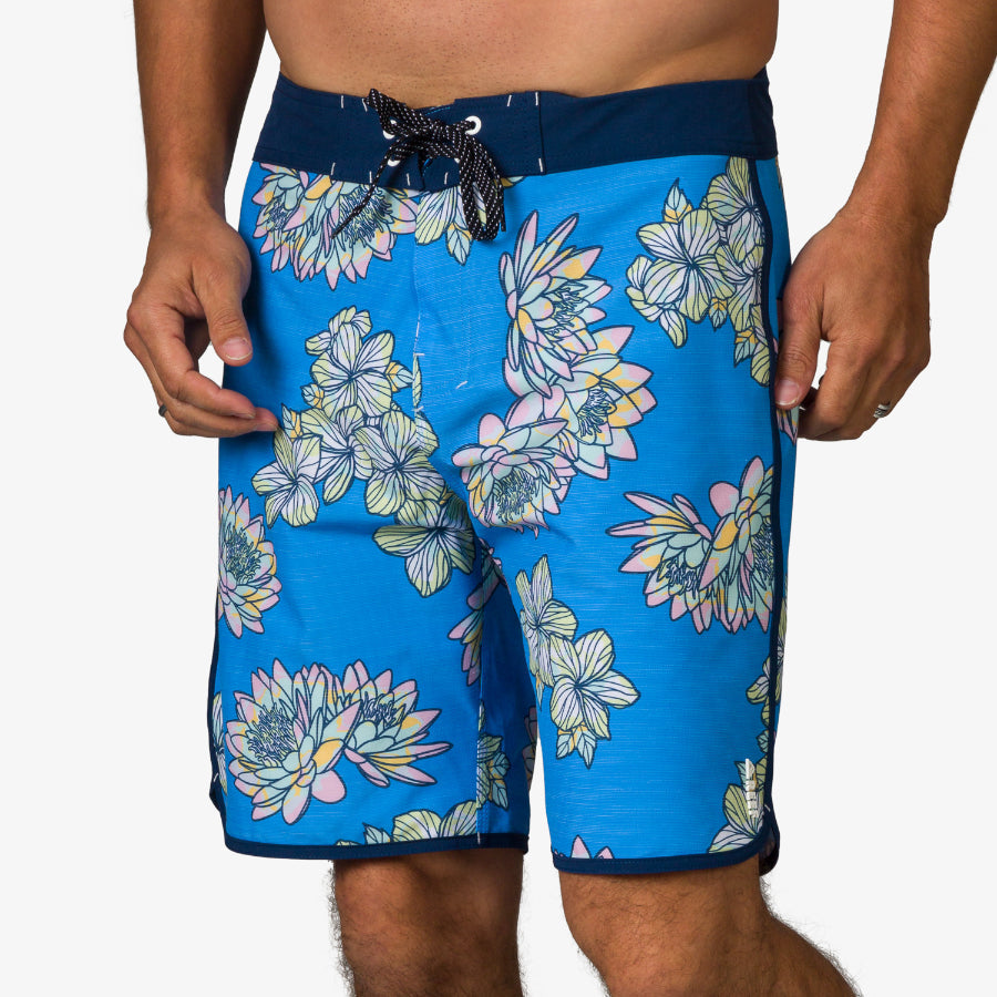 Front view of Tanner Boardshort with blue floral pattern and navy waistband, designed for comfort and beach wear.
