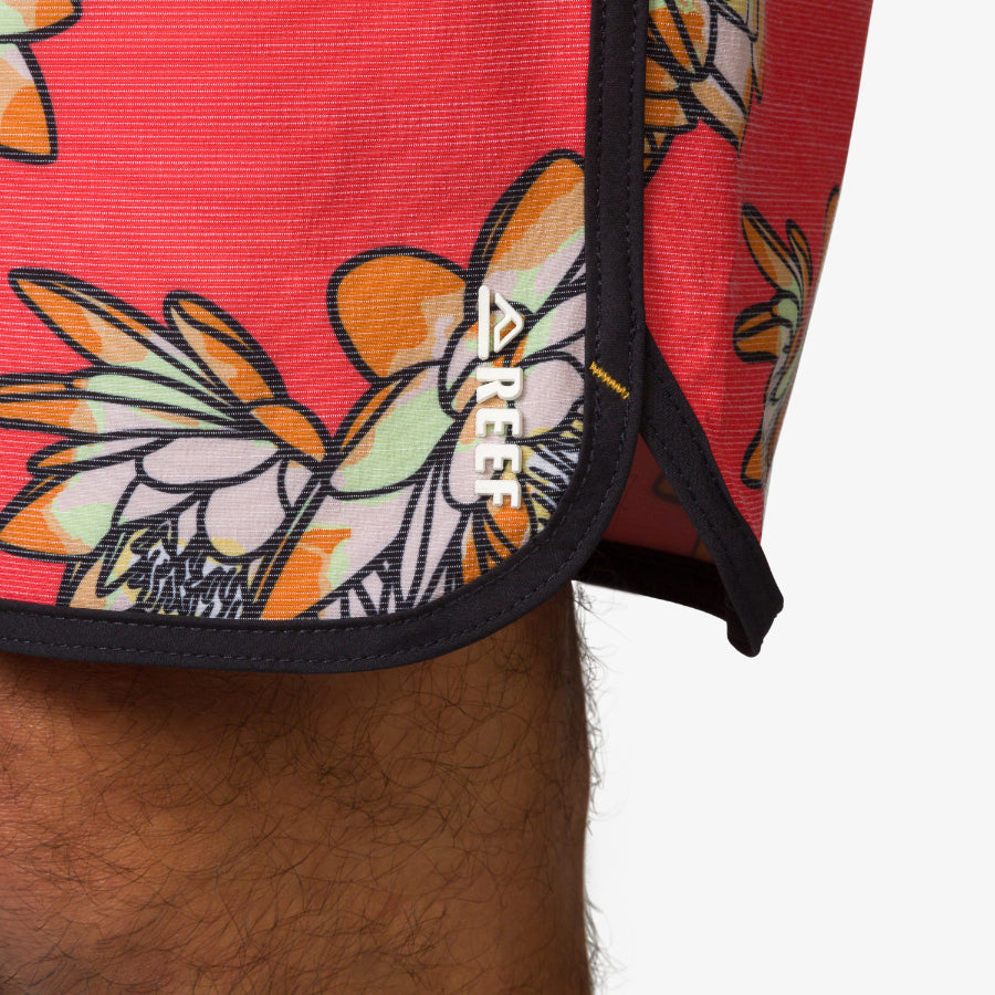 Close-up of Tanner Boardshort hem with floral print and REEF logo, designed for comfort and beach lifestyle.