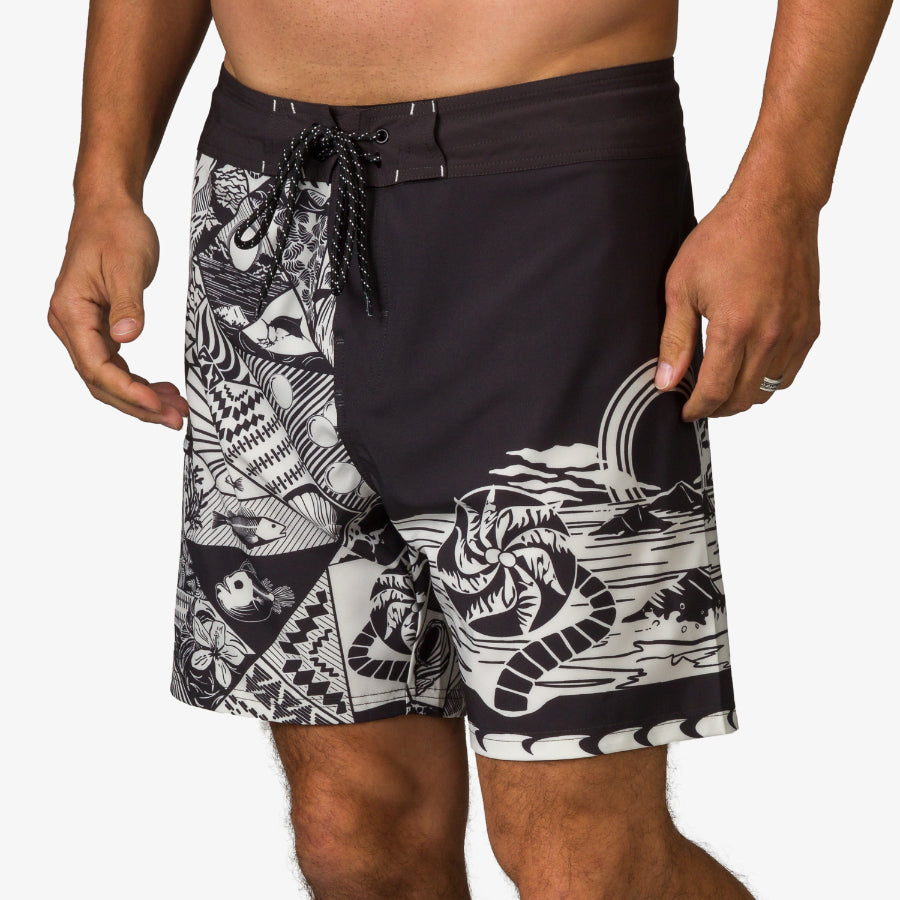Marshall Boardshort worn by man facing forward, featuring black and white surf-inspired pattern on water-friendly fabric.