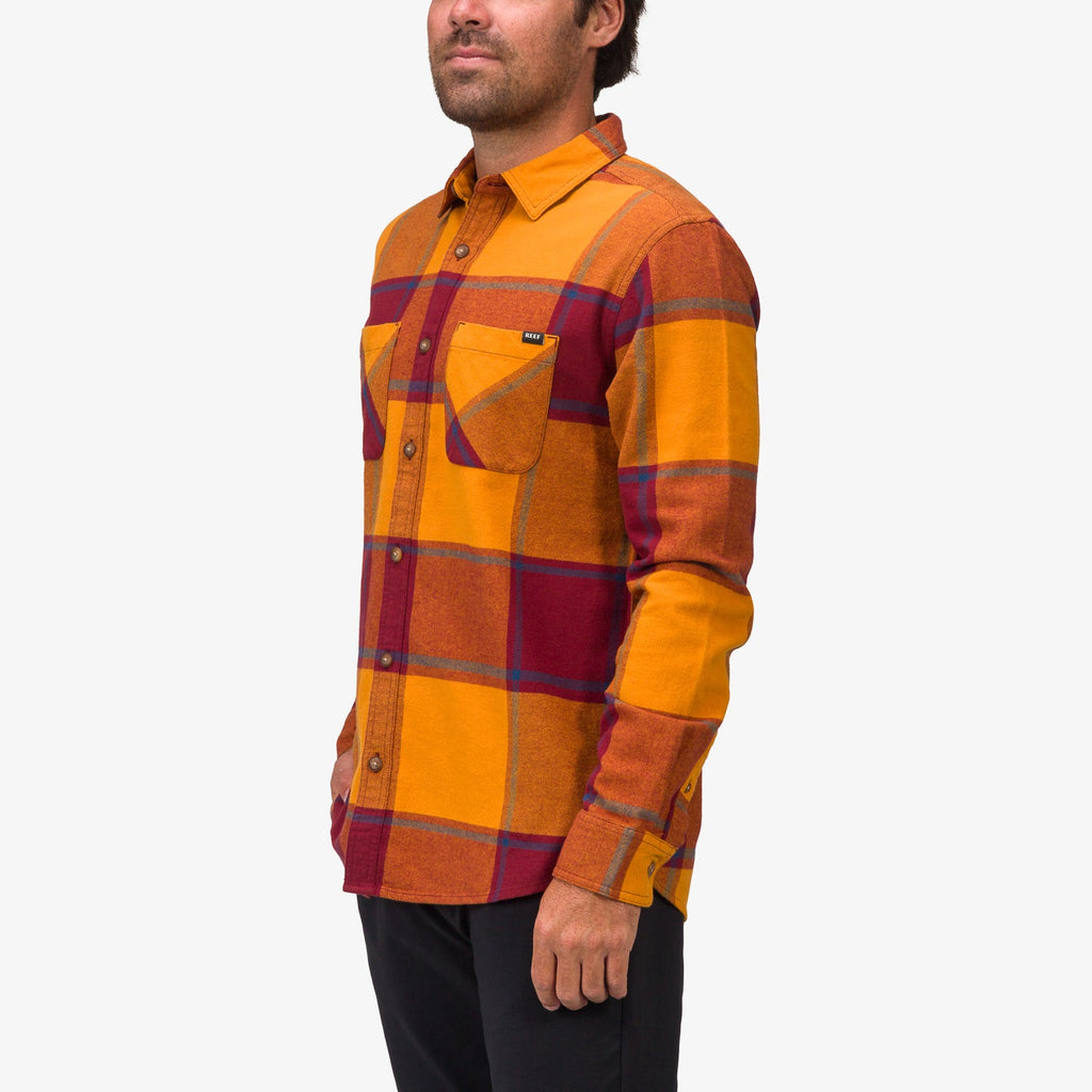 Side view of a man wearing the Morris Ls Wvn Shirt in orange and red plaid, showcasing comfort-focused apparel.