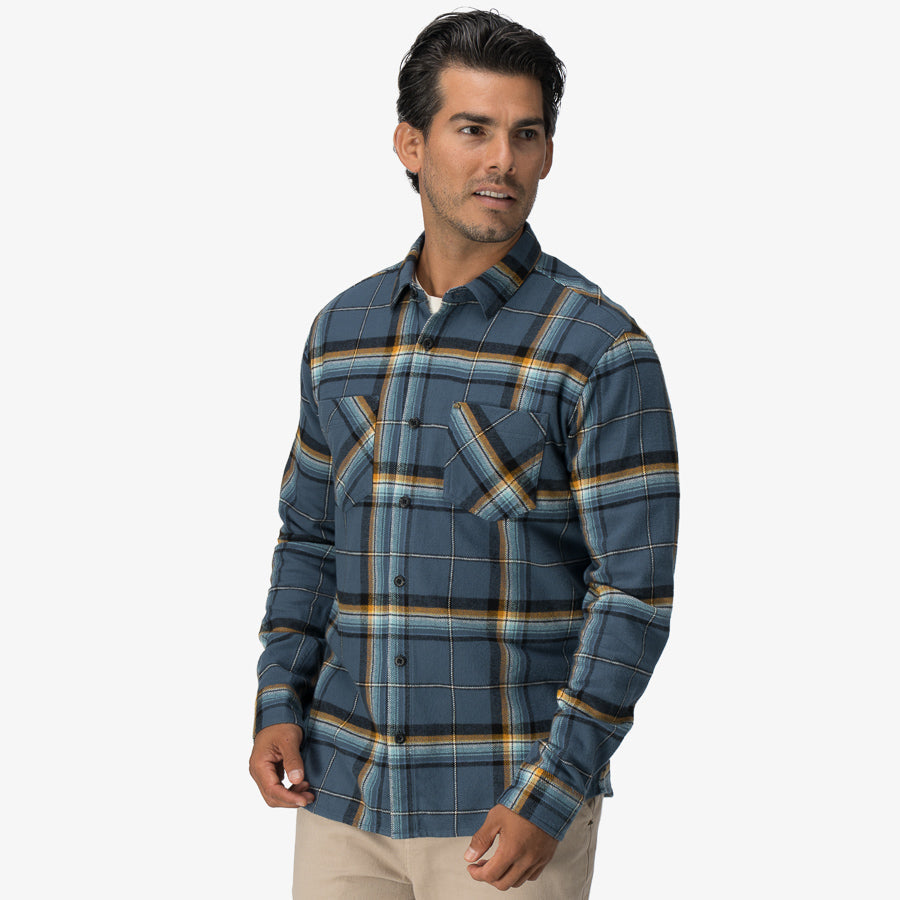 Man wearing a blue and yellow plaid Dyson Flannel Shirt, front view showcasing soft, comfortable beach-inspired apparel