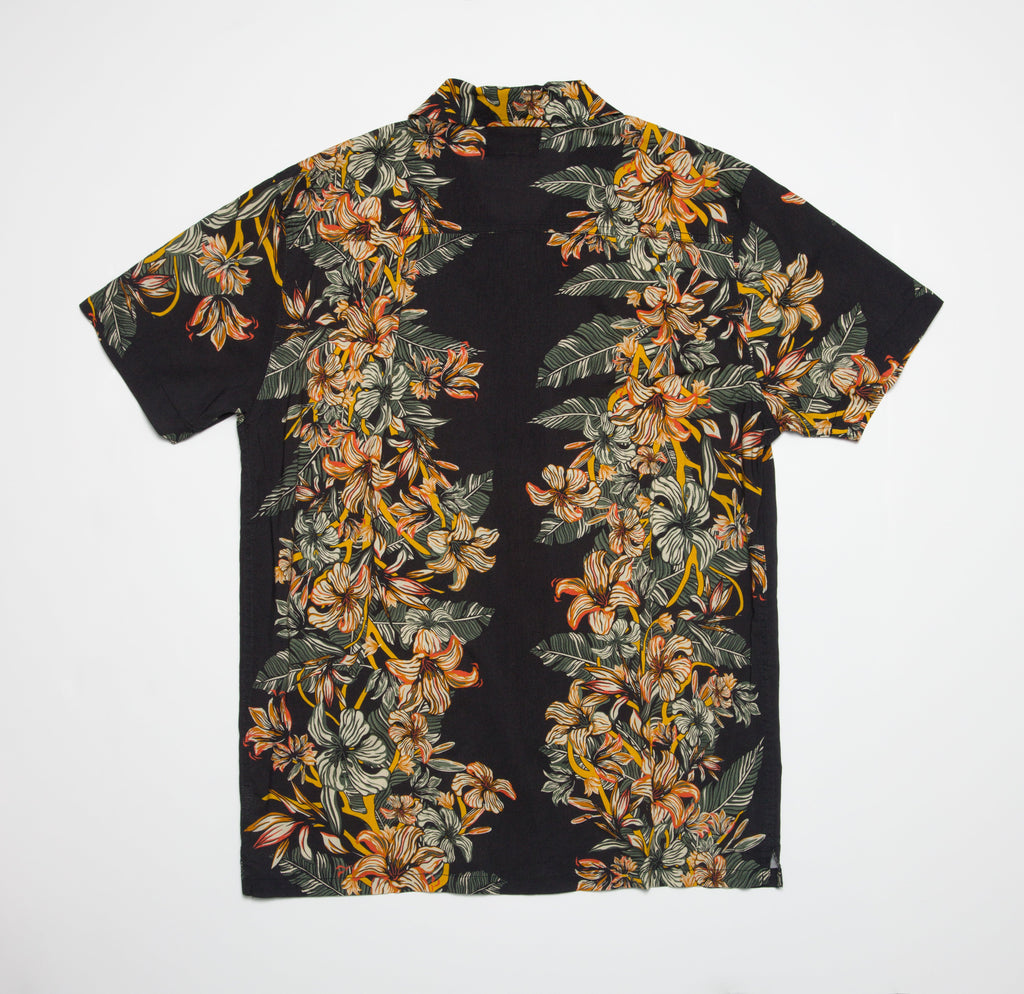 Drift Ss Camp Shirt flat lay showing black fabric with orange and yellow floral print, surf-inspired casual beach apparel.