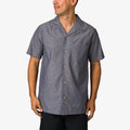 Man wearing a gray Harold Camp Shirt with short sleeves and button front, shown from the front and waist up.