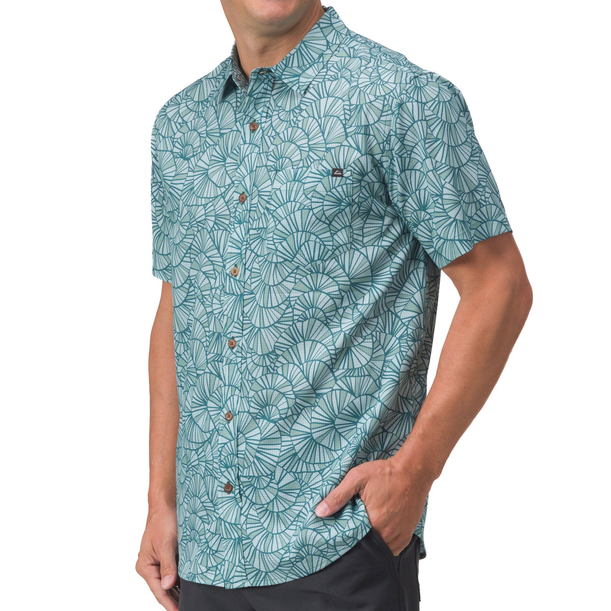Male model wearing a teal Hartman Woven Shirt with a surf-inspired pattern, highlighted from the front torso view.