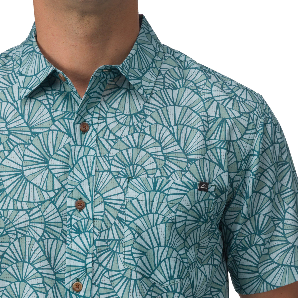 Close-up of the chest and collar on a Hartman Woven Shirt featuring a blue seashell pattern and wooden buttons.