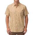 Front view of a man wearing a beige patterned Hartman Woven Shirt, designed for beach-inspired comfort and style.
