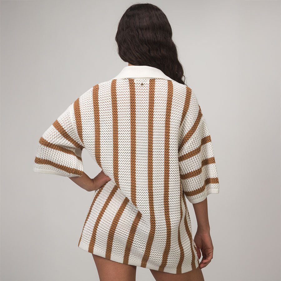 Woman wearing Mika Button Down Top in white with brown stripes, shown from back, featuring relaxed fit and textured knit fabric.