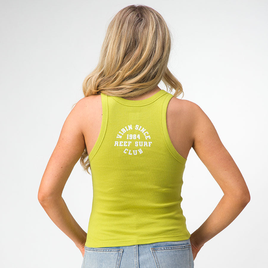 Woman wearing lime green Vibin Rib Tank showing back with Reef Surf Club logo, beach-inspired comfortable casual apparel.