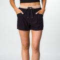 Front view of women's Robyn Short in black with beige waistband and drawstring, showcasing casual beach comfort style.