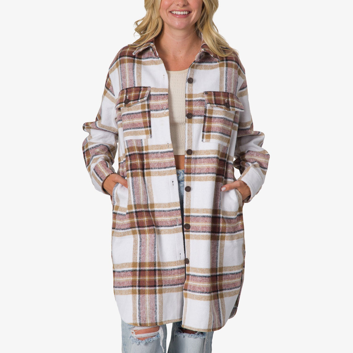 Woman wearing a front-facing Victoria Shacket in white and brown plaid, hands in side pockets, styled with ripped jeans and a light top.