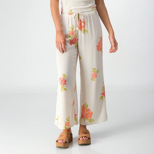 Front view of Belladona Pant in white with floral print, paired with tan platform sandals for beach-inspired comfort.