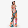 Woman wearing colorful floral Eve Wide Leg Romper standing with relaxed posture, full body view for beach lifestyle apparel.