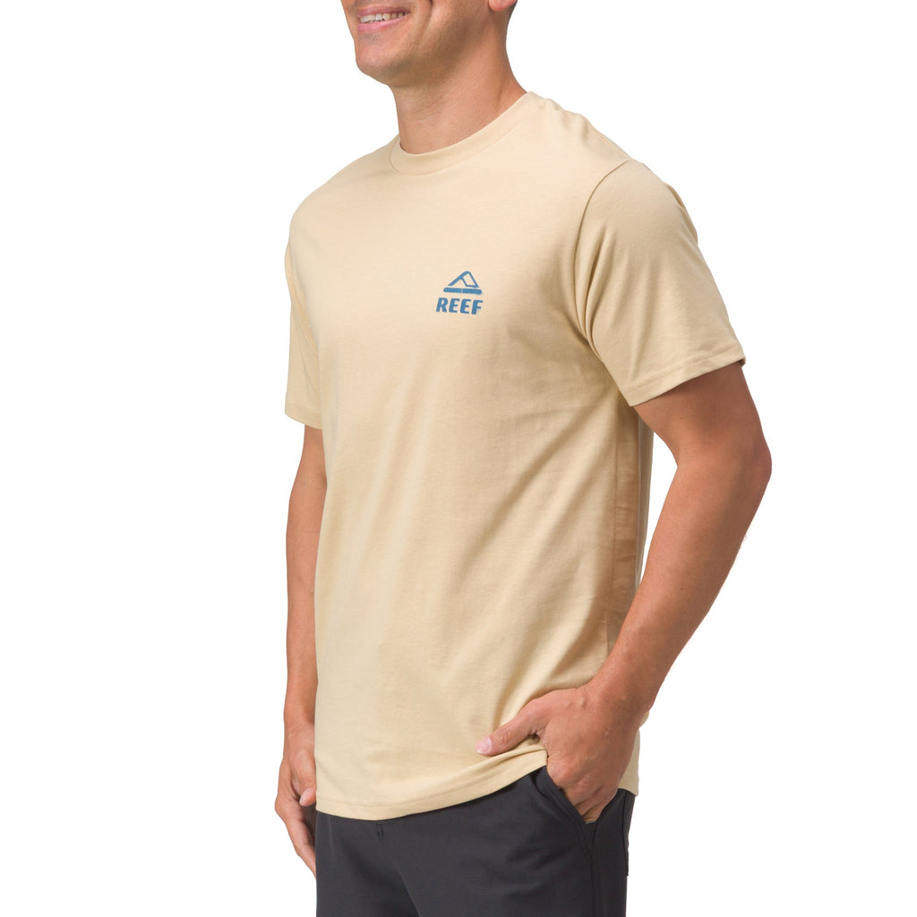 Man wearing beige Xavier Tee facing front right with a small blue logo, beach-inspired comfort apparel for men.