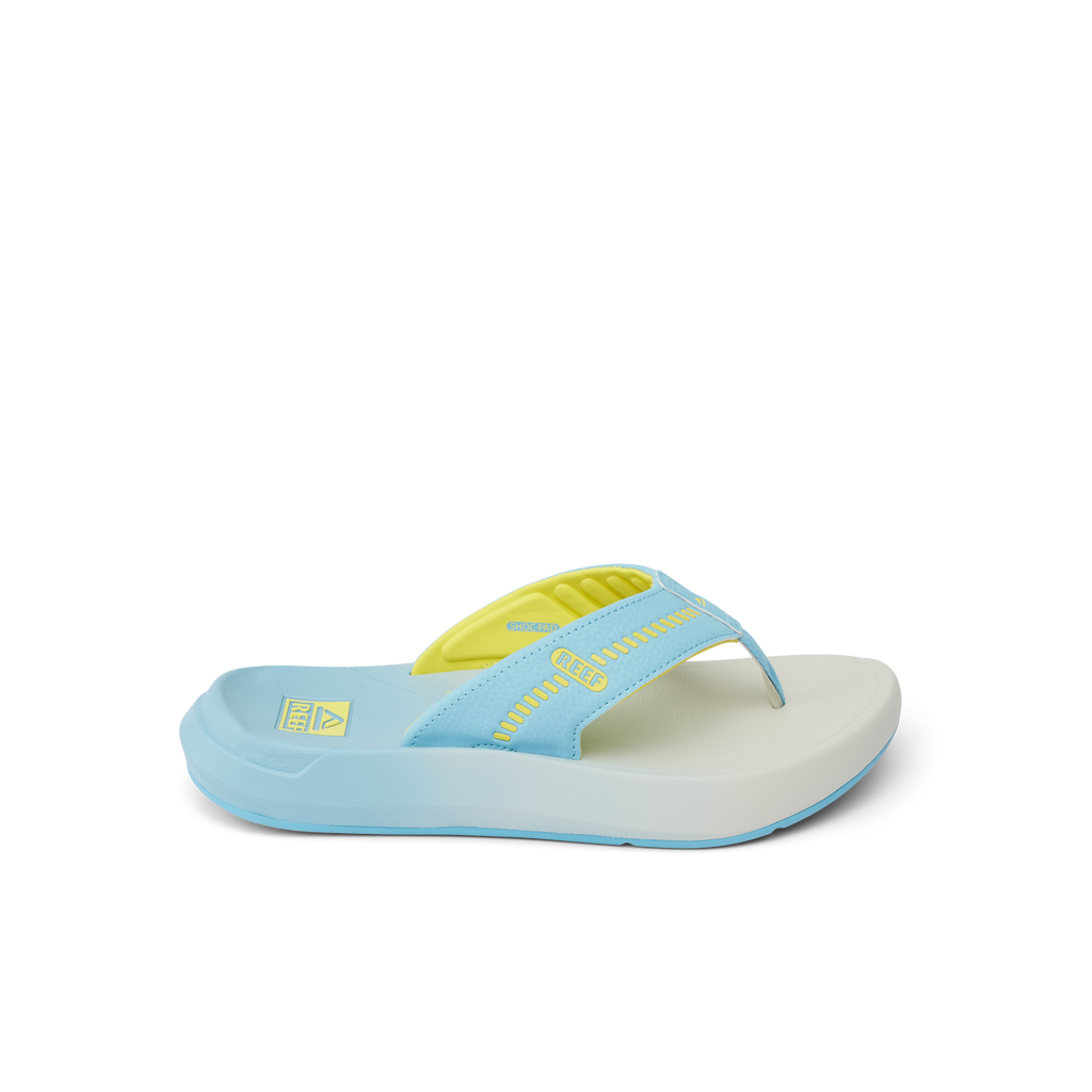 Cruiser sandal facing right, close-up of light blue and yellow slip-on with cushioned arch support and water-friendly sole.