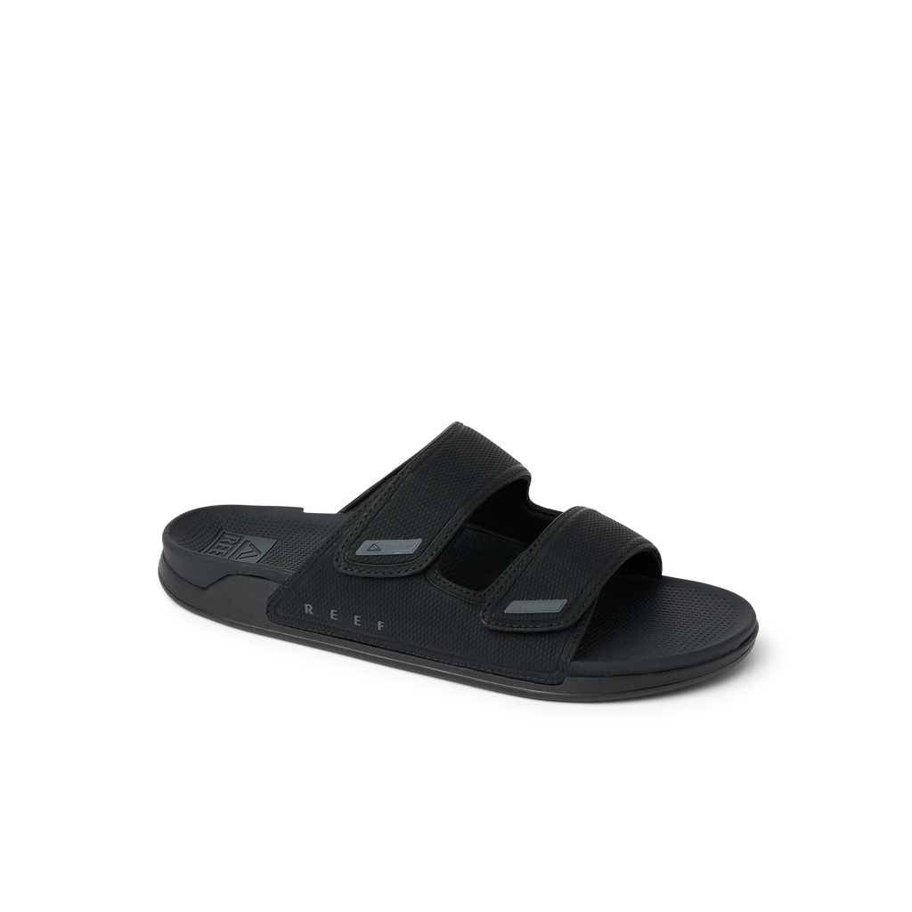 Phantom Tradewind men’s black sandal facing right, featuring dual straps with anatomical arch support and soft cushioning.
