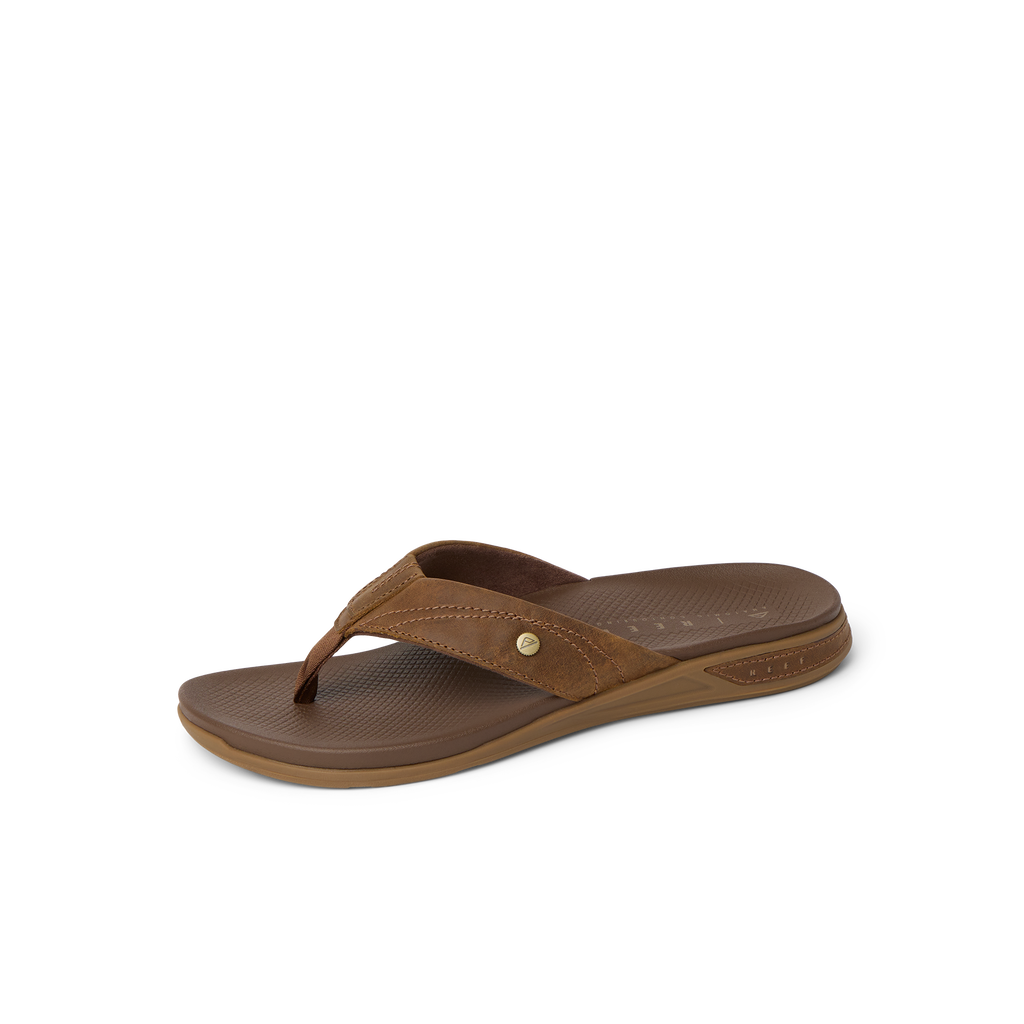 Phantom Lux men's brown sandal facing left, close-up of footbed and strap with anatomical arch support and cushioning.