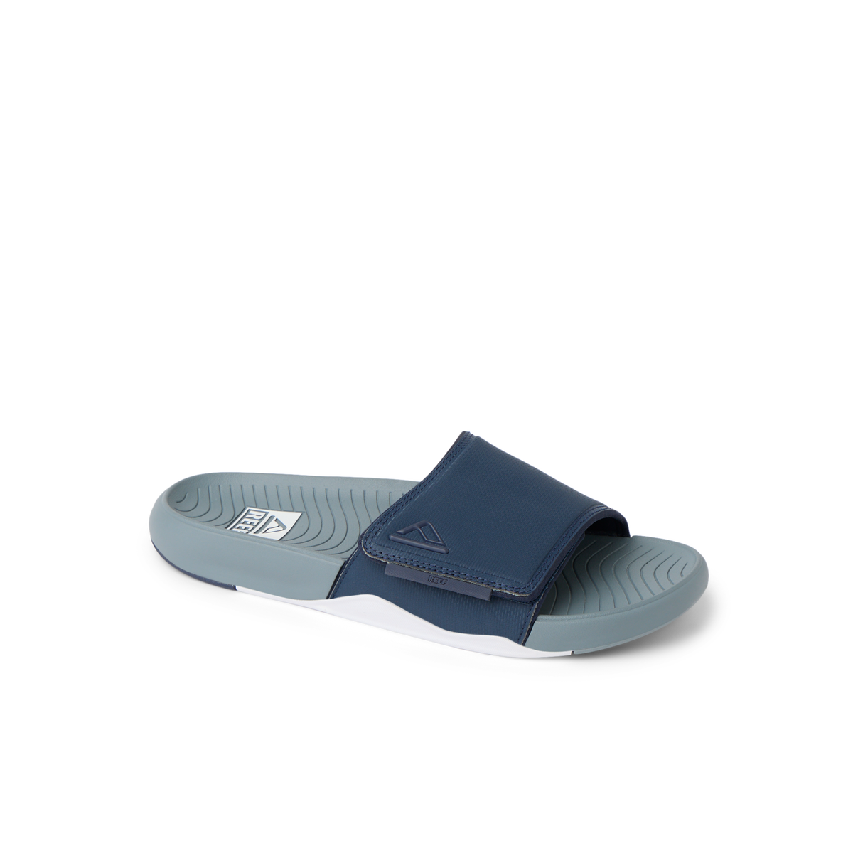 Phantom Slab slide facing left showing navy upper strap and gray molded footbed with arch support, surf-inspired comfort footwear.