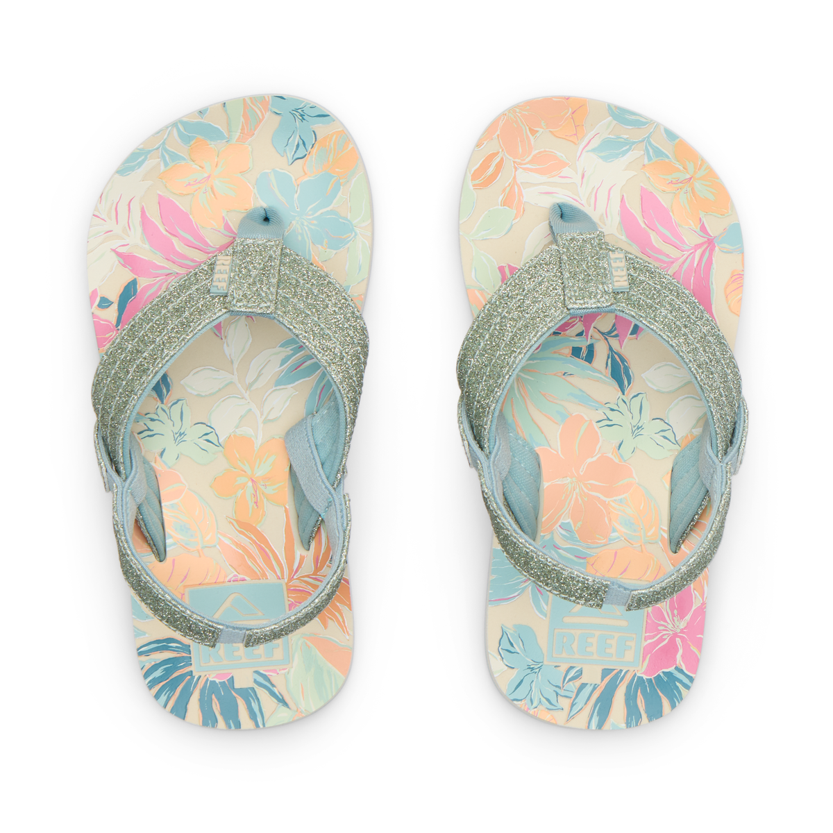 Top view of Little Ahi girls' sandals with tropical floral print footbed and glittery straps, designed for comfort and beach use.