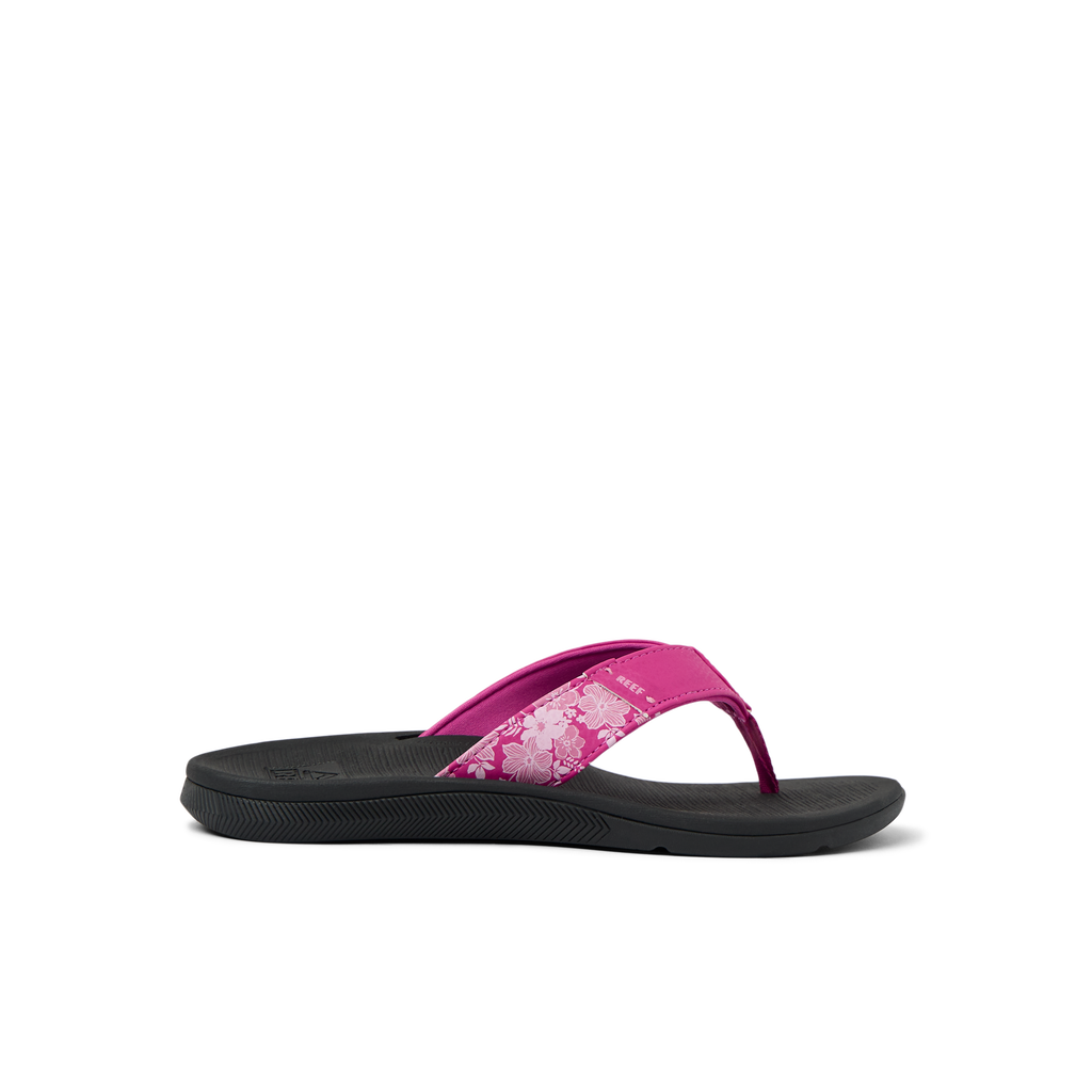 Santa Ana women's flip flop facing left, pink floral strap with black cushioned sole, beach-inspired comfort design.