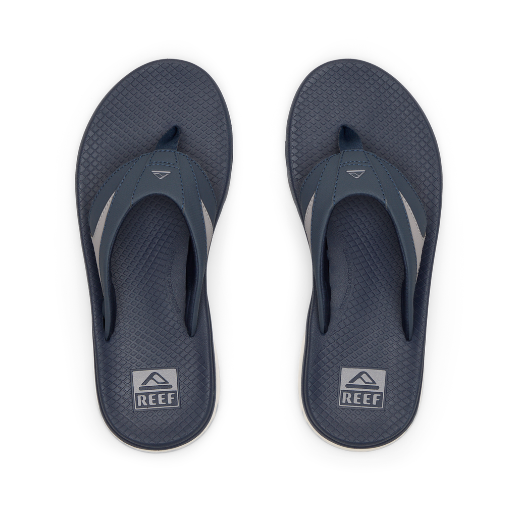 Pair of men's Fanning + flip flops facing upward, navy and grey, with anatomical arch support and cushioned footbeds