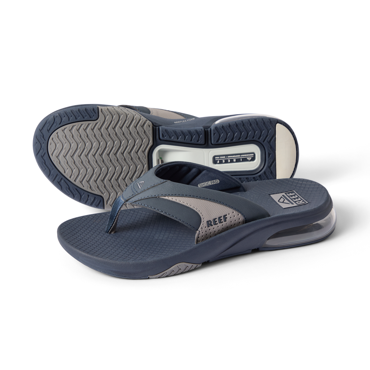 Fanning + men’s navy gray flip flops, angled left showing top and sole, comfort cushioning and arch support