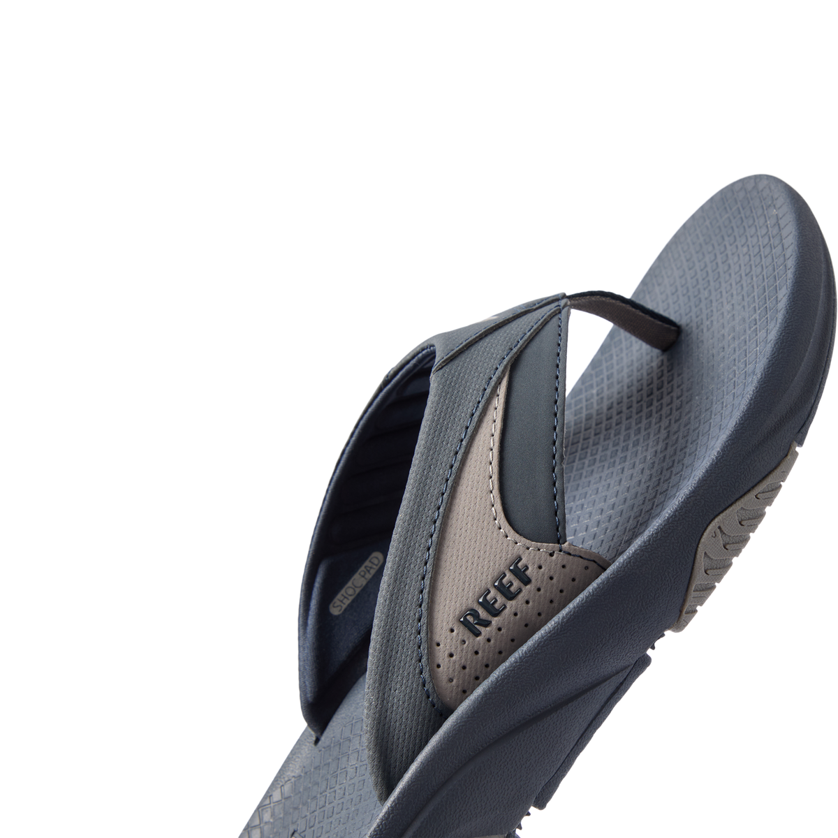 Right side view of Fanning + men's sandal showing navy and grey straps with REEF logo and cushioned footbed