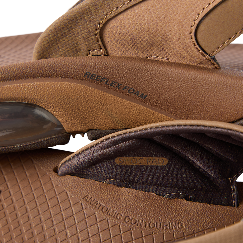 Close-up of the side and inner strap of the Fanning + sandal showing cushioning and shock pad details facing left.