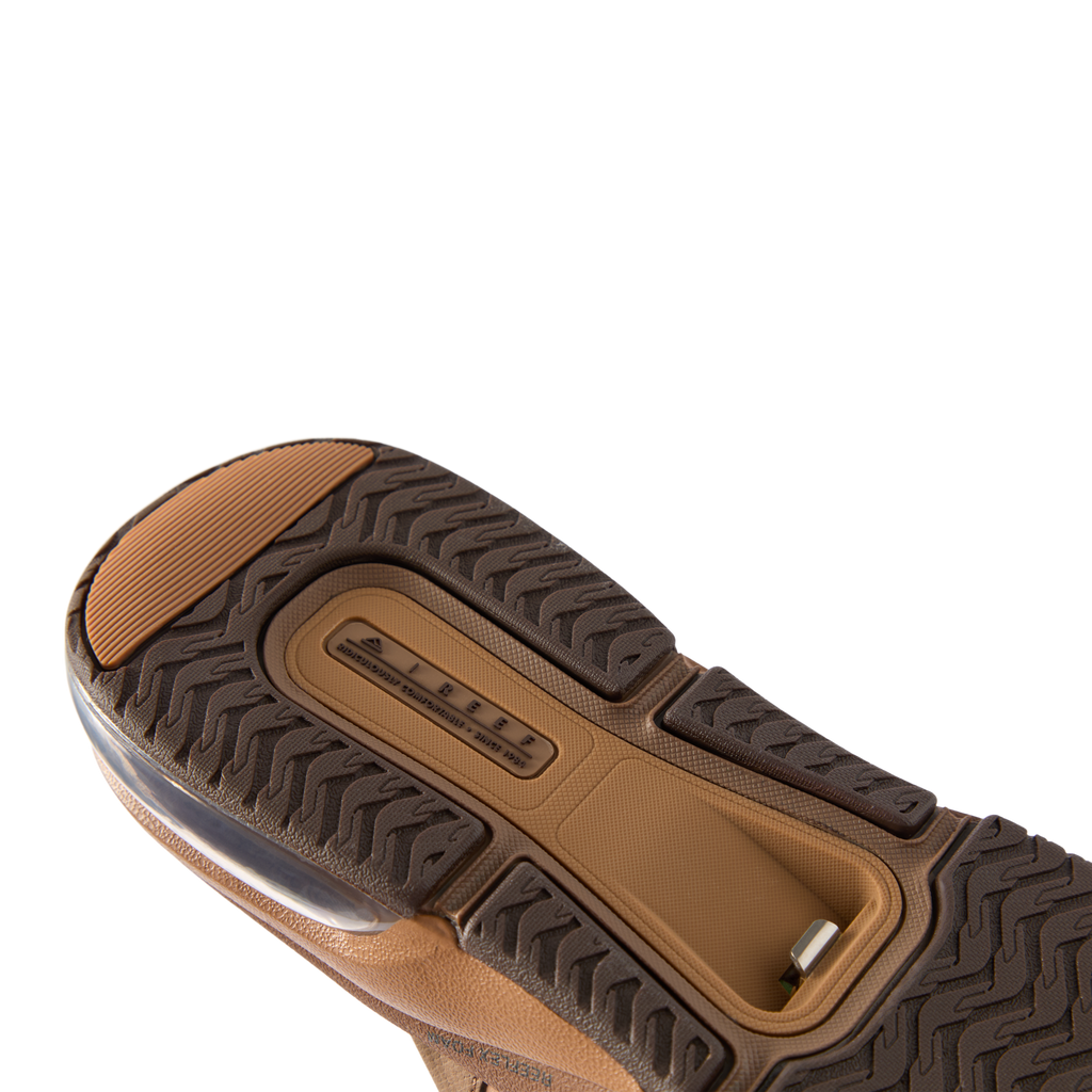 Fanning + men's shoe sole facing up, showing durable tread and comfort-focused cushioning with arch support features.