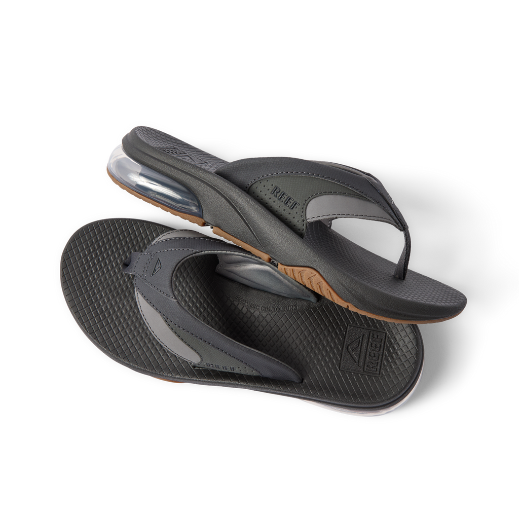 Fanning + men’s black flip flops with arch support and cushioned sole, right footwear side view and sole close-up shot