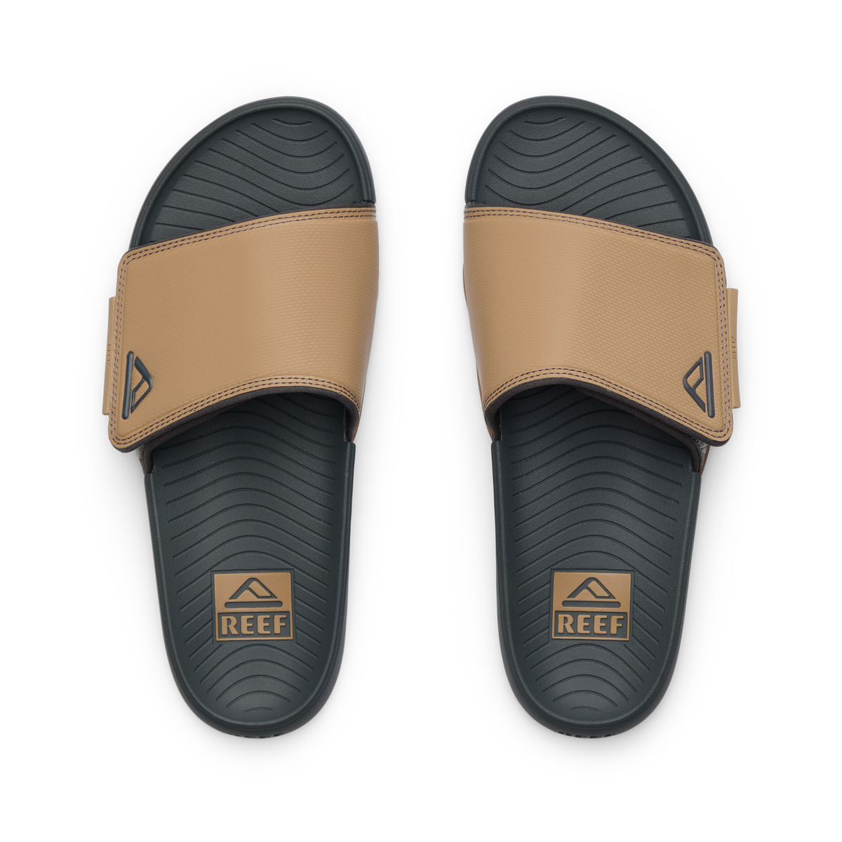 Phantom Slab men's slides facing up, tan straps with REEF logo, cushioned footbed with arch support for beach comfort.