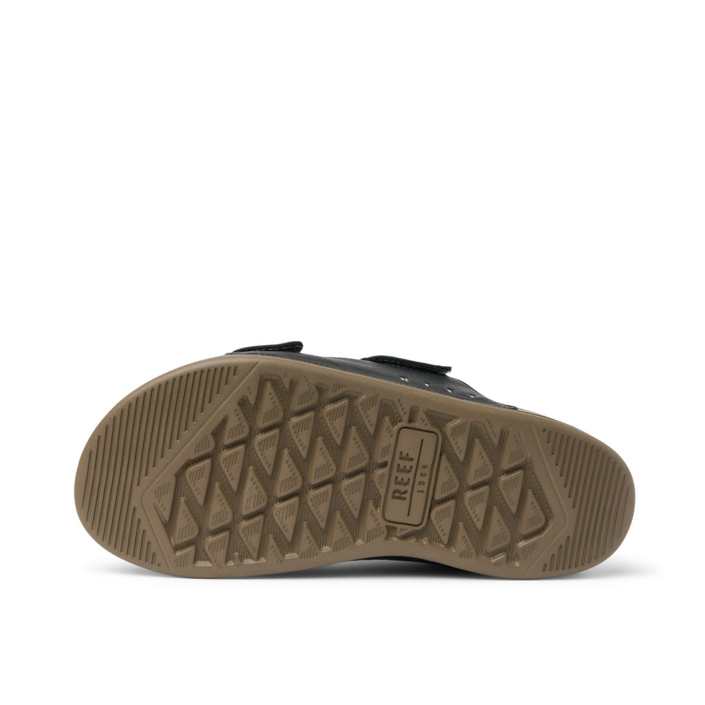 Phantom Tradewind men's shoe sole facing up, showing durable tread with REEF branding for beach comfort and support.