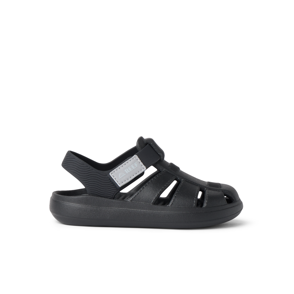 Little Totally Beachin black boys sandal facing left, close-up of lightweight, cushioned beach-inspired footwear.