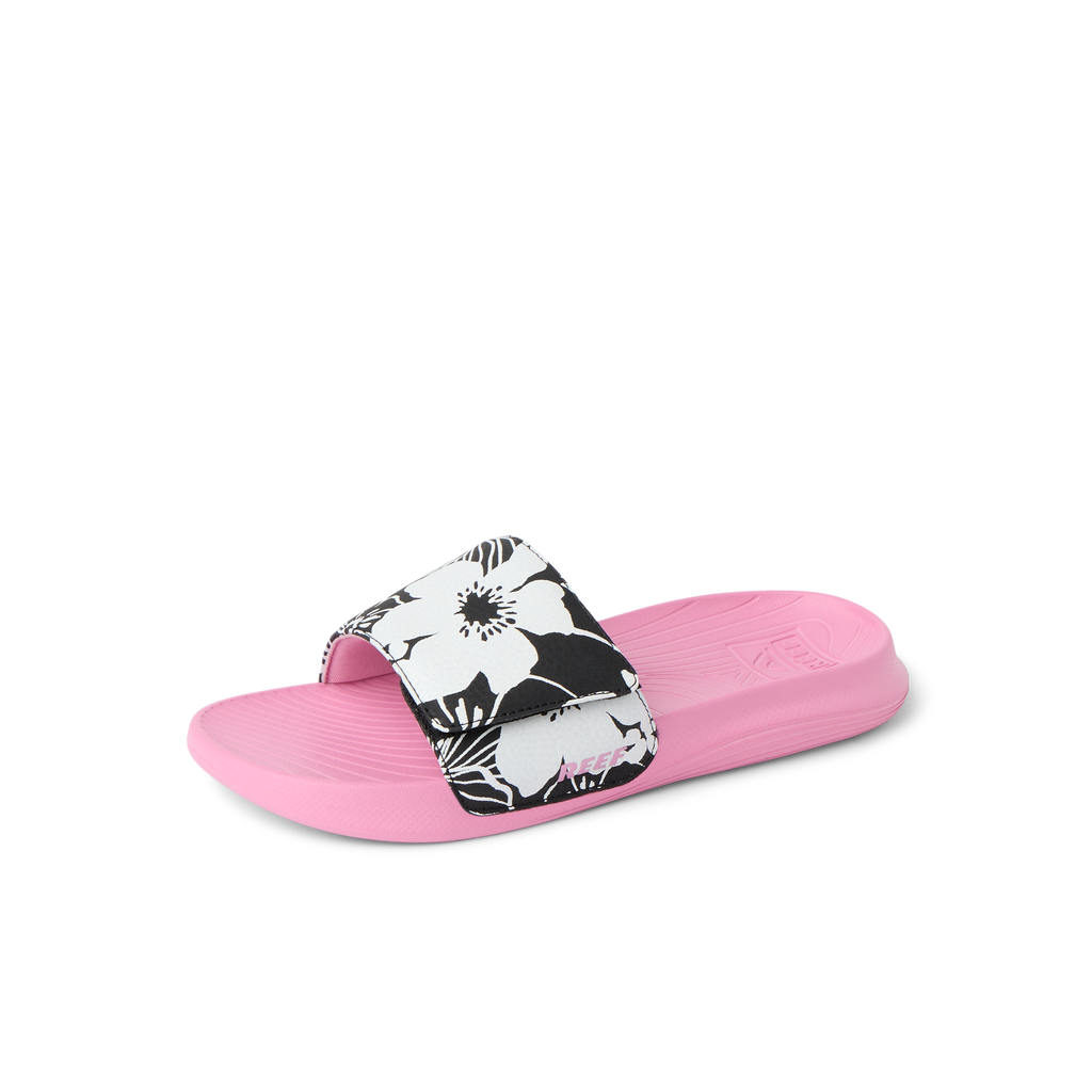 Kids Salty Slide sandal for girls, facing left, pink sole with black and white floral strap, surf-inspired comfort slide.