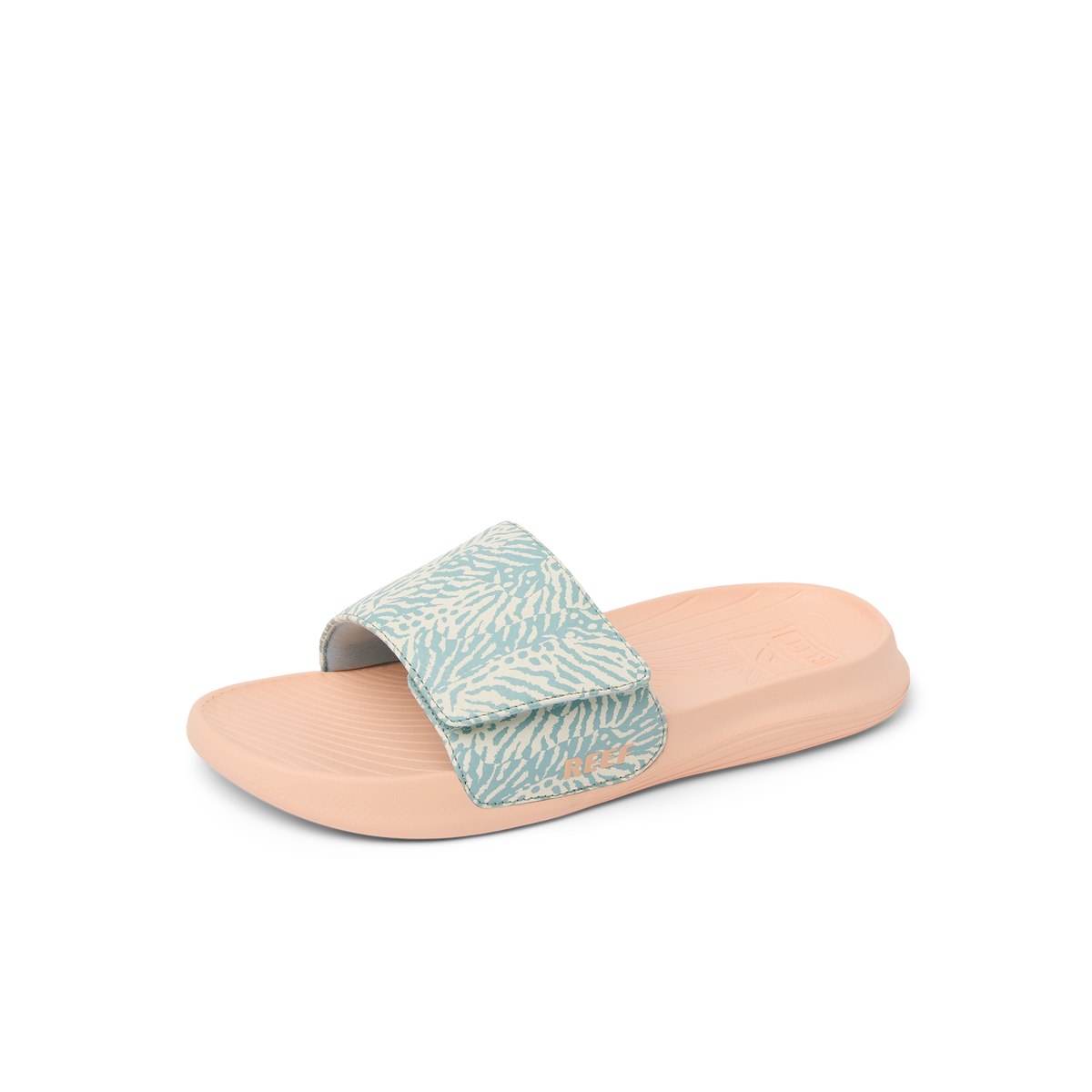 Kids Salty Slide facing right, close-up of blue haze patterned strap and peach footbed with arch support and cushioning