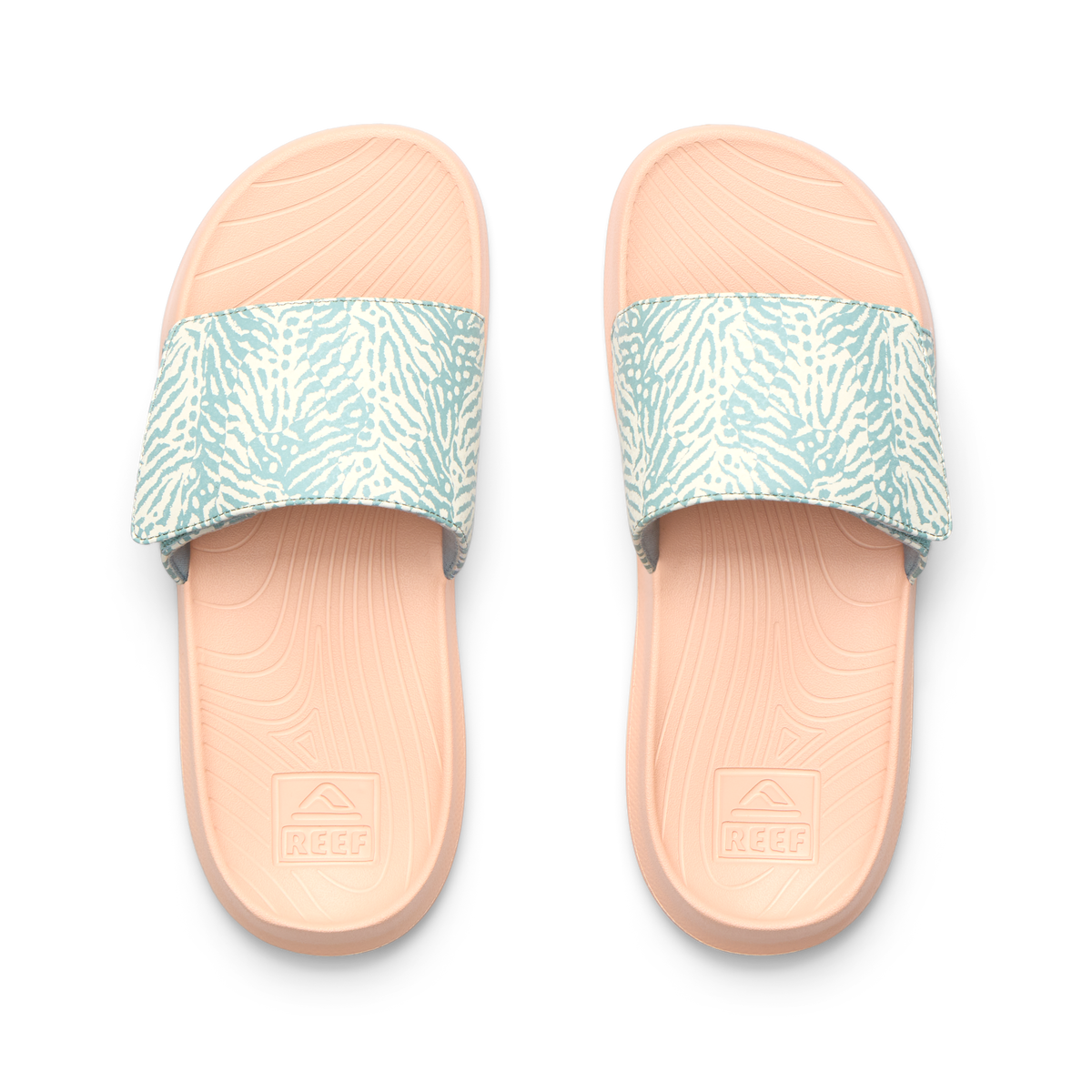 Kids Salty Slide top view showing blue patterned straps and peach cushioned footbeds with anatomical arch support, facing up.