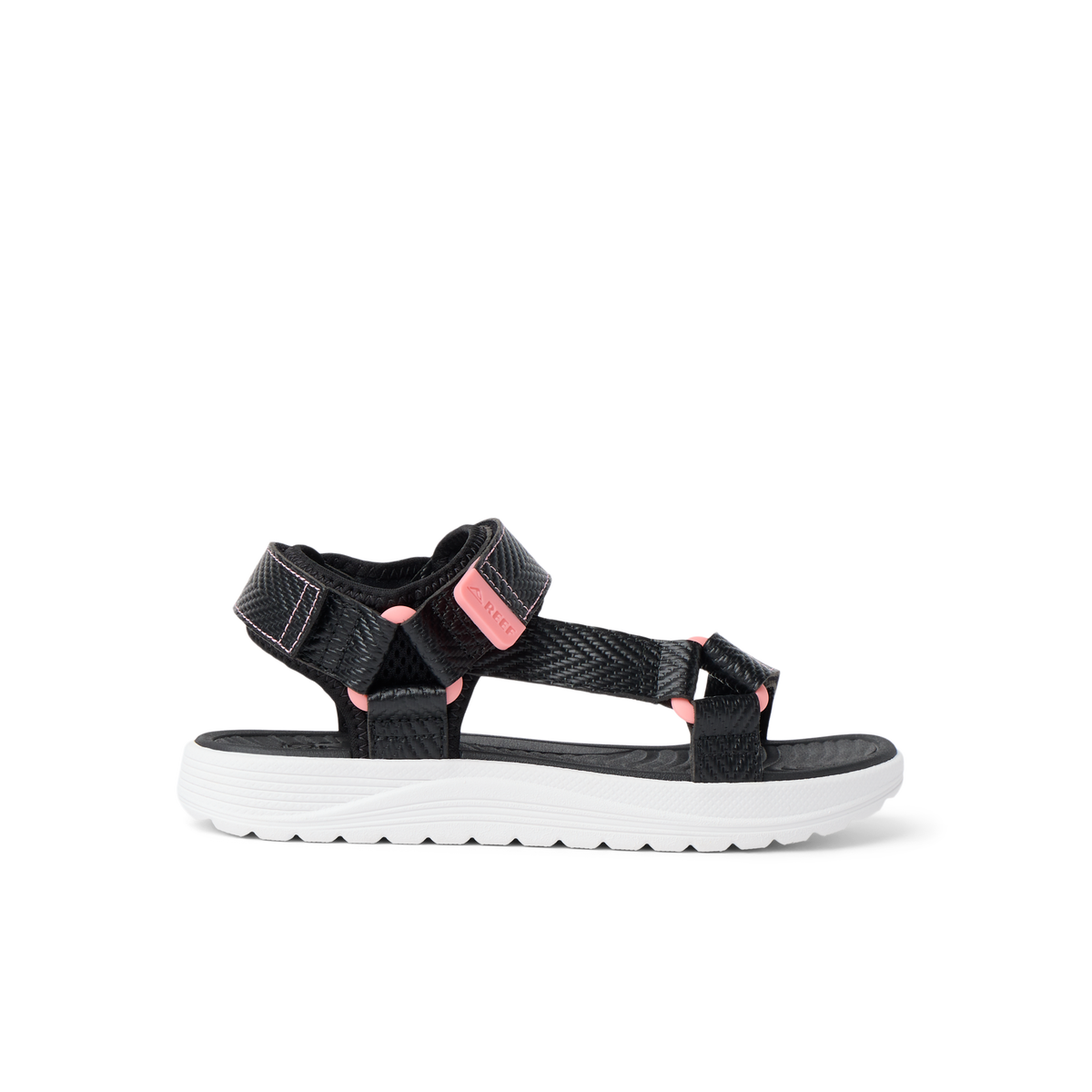 Kids Shoremazing sandal for girls facing right, featuring black straps with pink accents and cushioned white sole.
