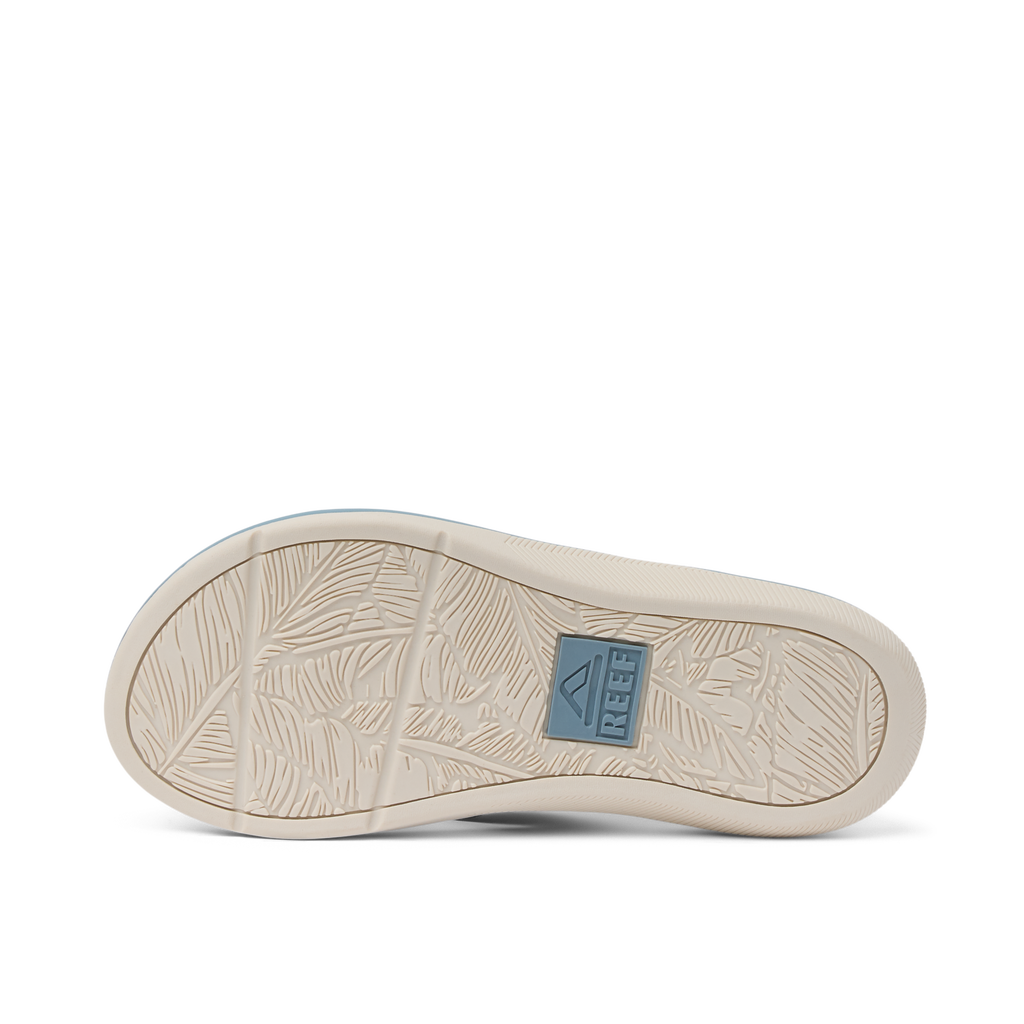Kids Santa Ana showing the outsole facing upward with textured beach-inspired grip and REEF logo patch in blue.
