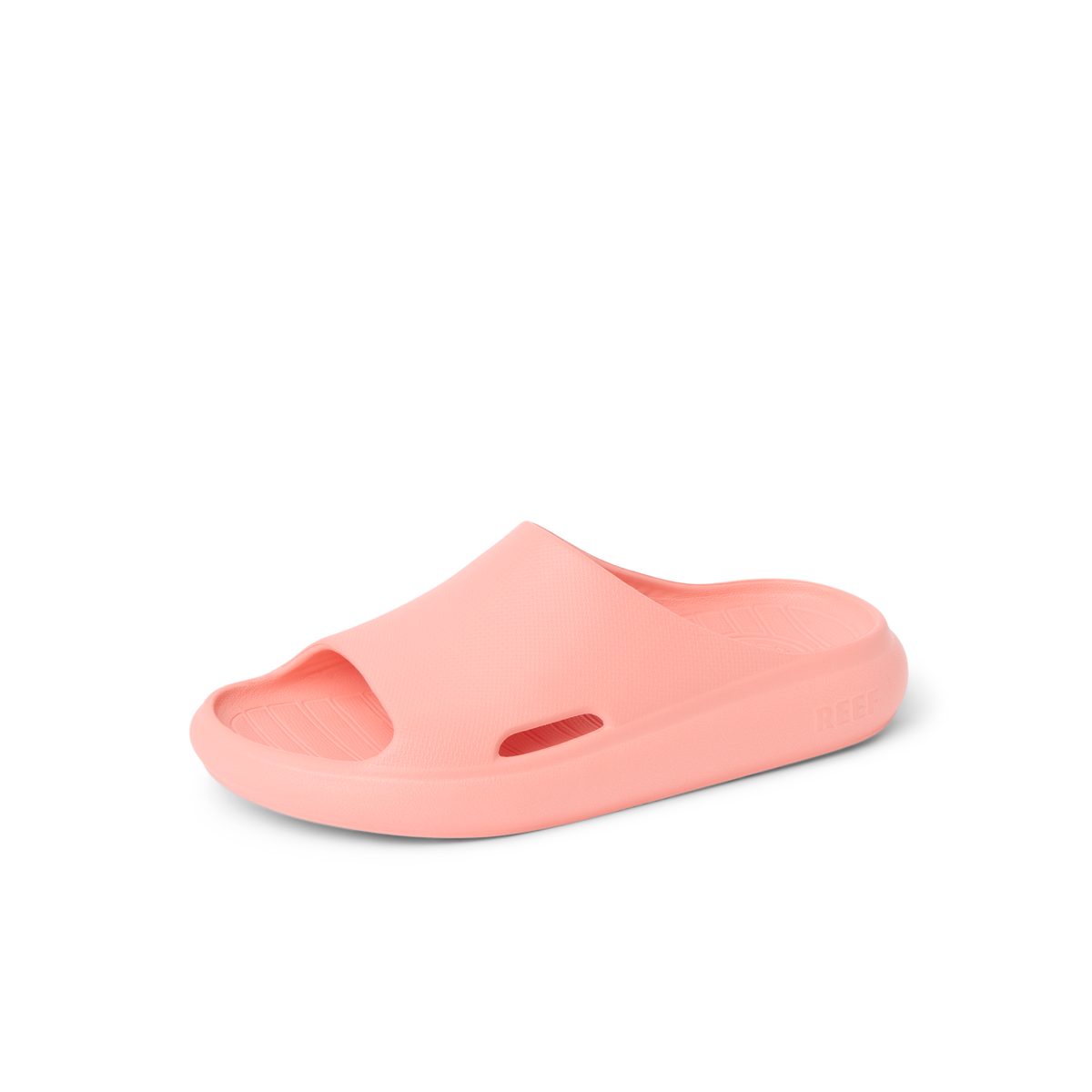Kids Rio Slide coral unisex sandal facing right, close-up of lightweight, water-friendly molded footbed and arch support.
