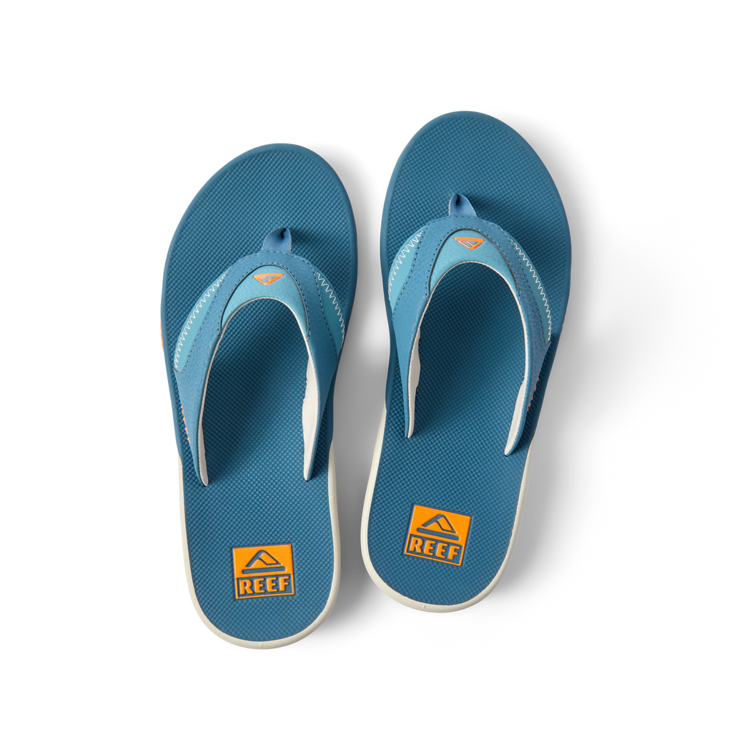 Pair of Fanning flip flops facing up showing toe post and cushioned footbed in steel blue and marigold colors.