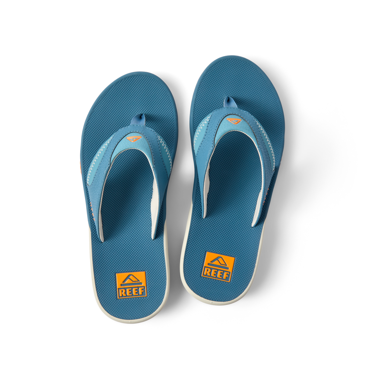 Pair of Fanning flip flops facing up showing toe post and cushioned footbed in steel blue and marigold colors.