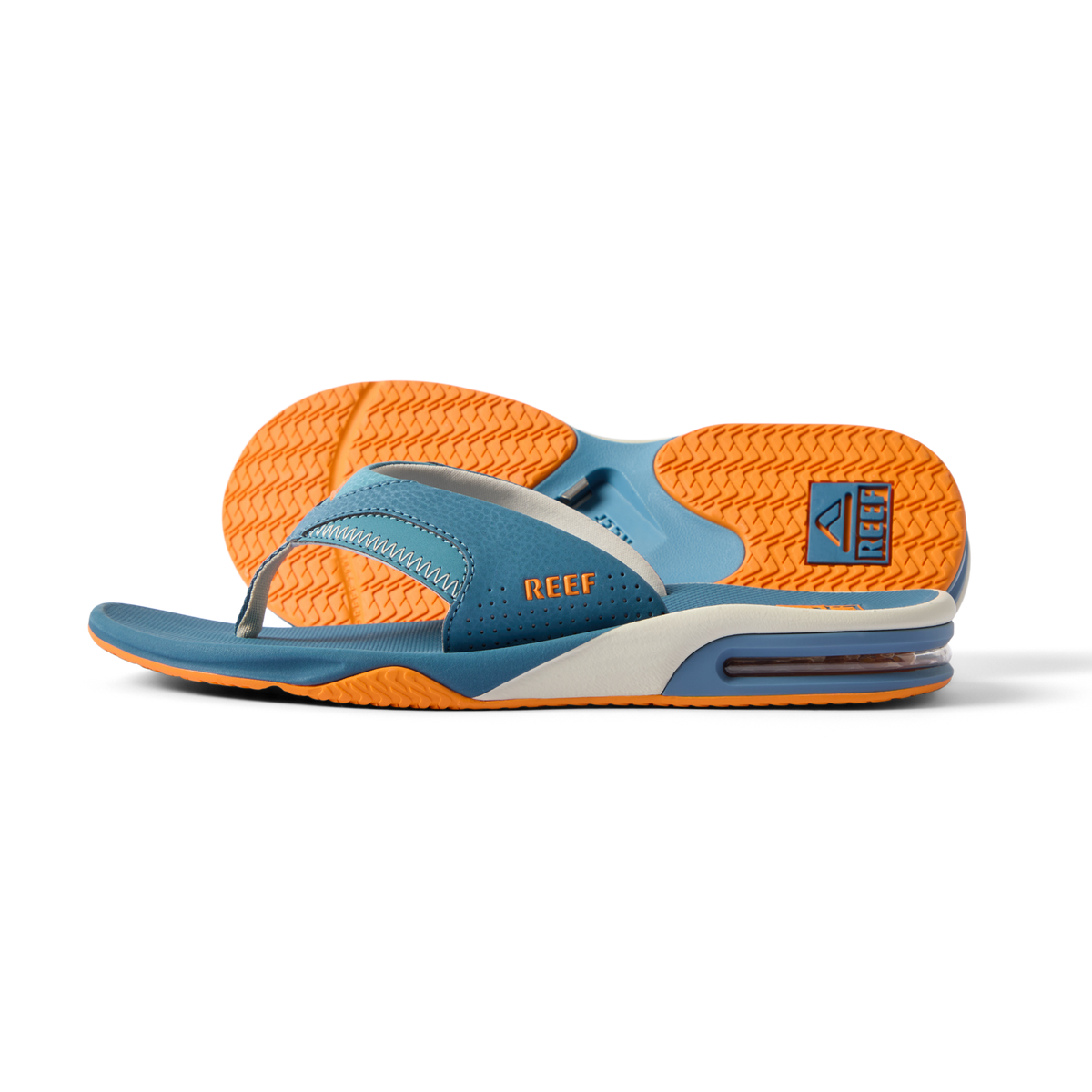 Fanning men’s sandal facing left, showing side and bottom with blue and orange colors, featuring arch support and cushioning.