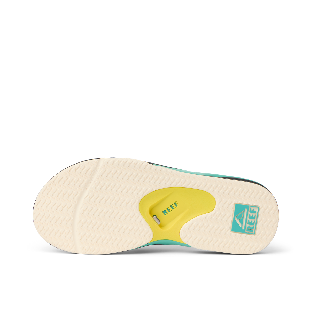 Fanning outsole facing up showing slip-resistant tread and arch cushioning with REEF branding in teal and yellow