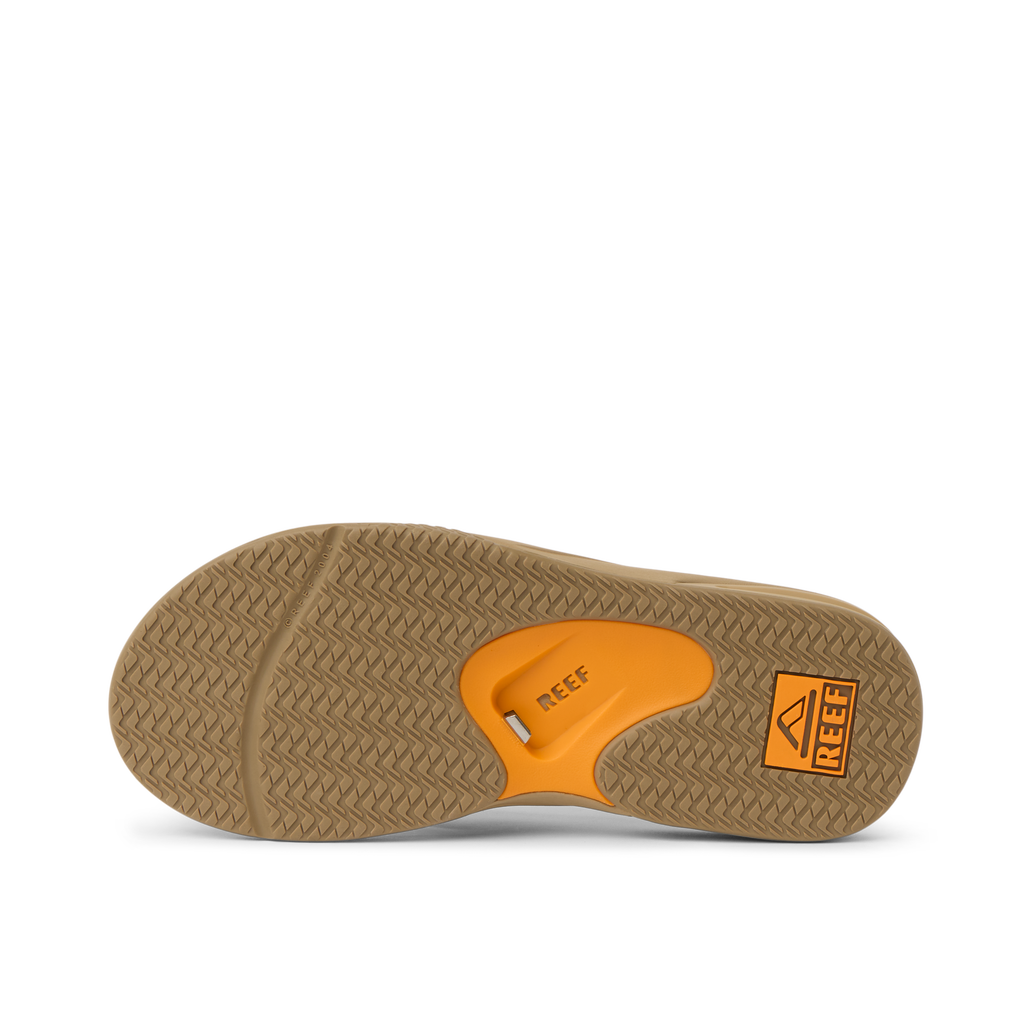 Fanning men's sandal sole facing up showing orange REEF arch support, soft-rebound cushioning, beach-ready comfort