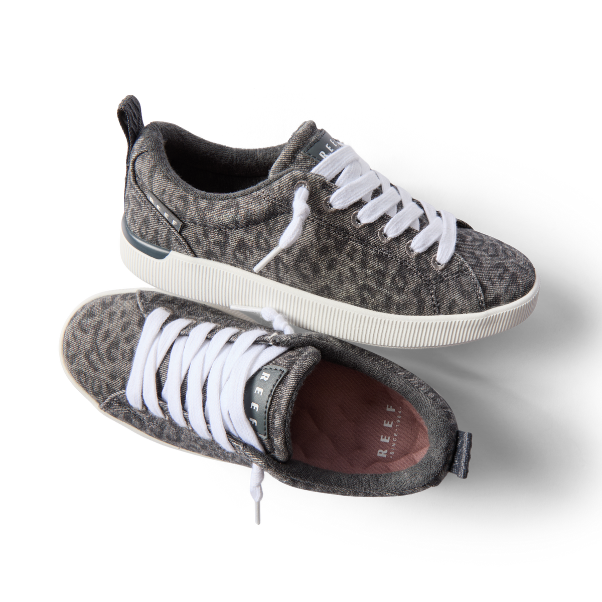 Pair of Neptune Alana women's sneakers with denim cheetah print, white laces, and anatomical arch support, top and side views.