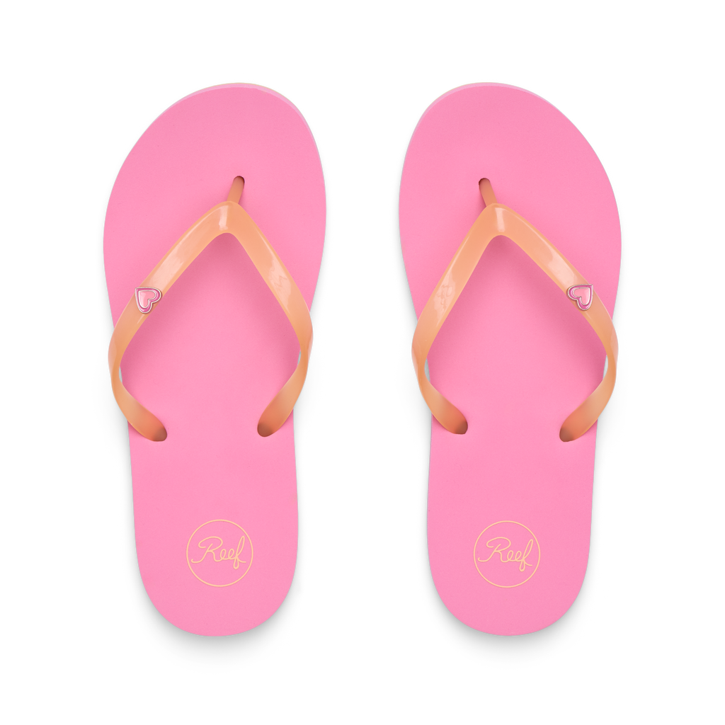Kids Charming pink flip flops facing up, close-up of soft, water-friendly straps with heart charm and cushioned footbed.