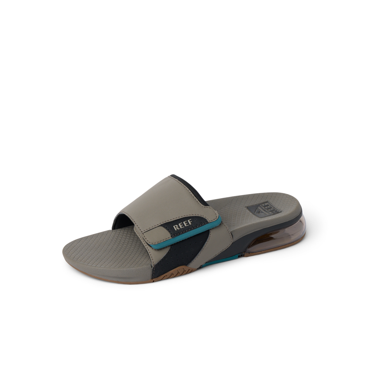 Fanning + Slide facing left, men's tan and spruce water-friendly slide with oversized airbag heel and cushioned footbed