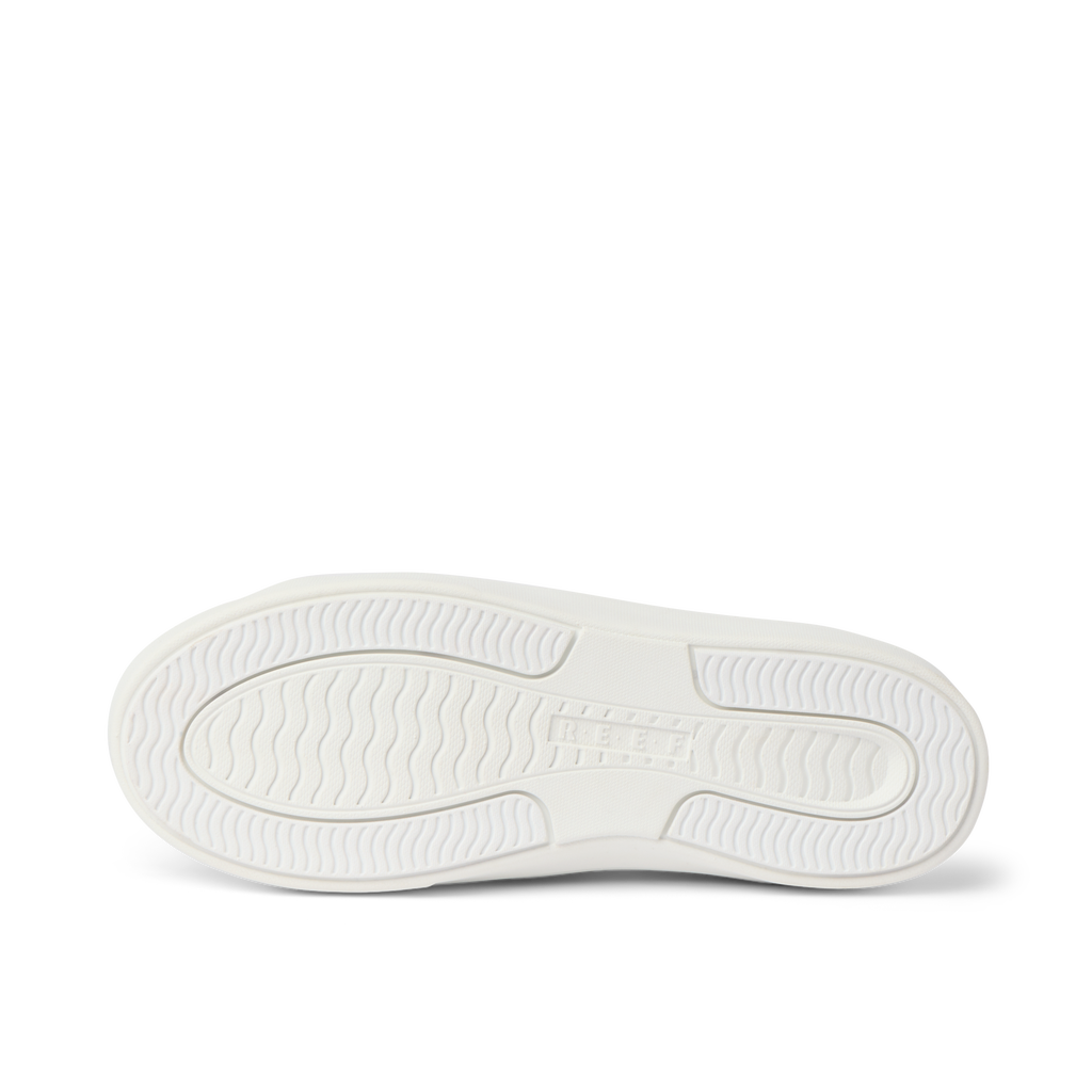 Lay Day Lite white shoe sole close-up, showing durable, water-friendly outsole with wave-inspired tread pattern facing upward.